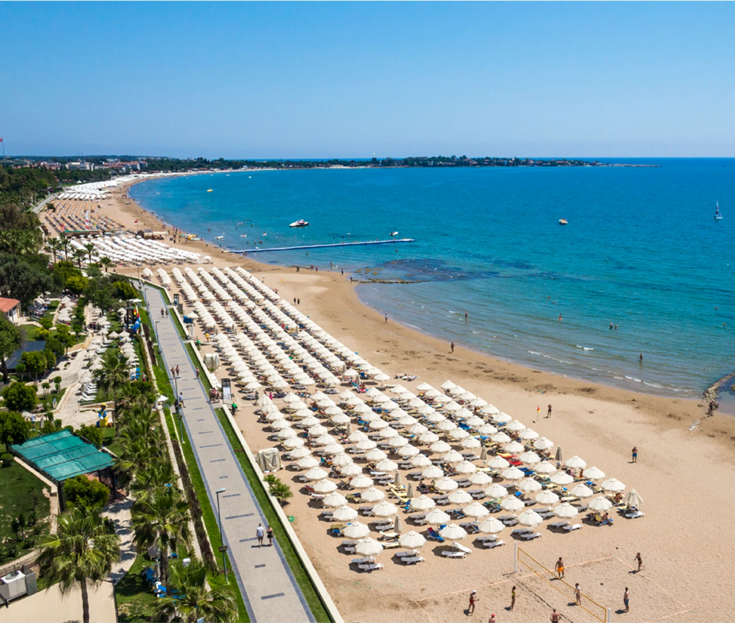 Aerial view of the private sandy beach and seafront promenade at Club Melas Privé in Side